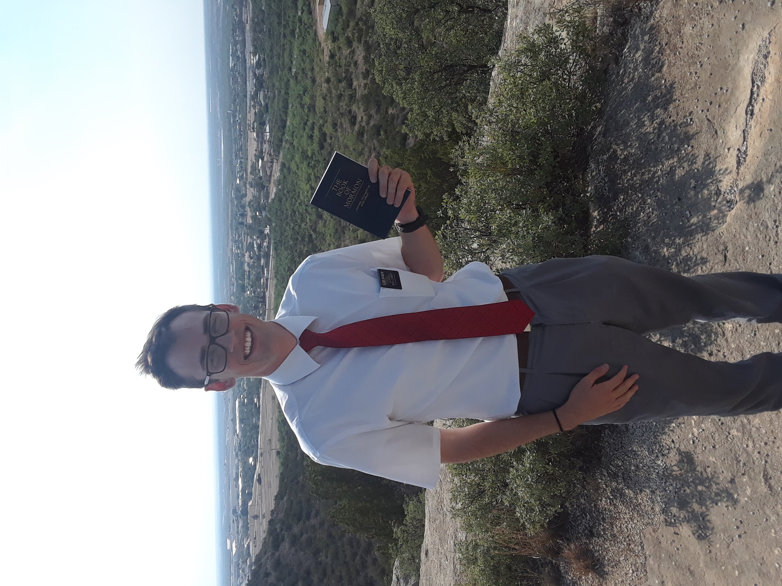 Me on my mission, holding a Book of Mormon
